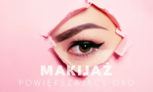 Zbliżenie na oko z makijażem powiększającym spojrzenie, przebijające przez różowy papier.