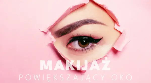 Zbliżenie na oko z makijażem, widoczne przez dziurę w różowym papierze.