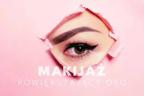 Zbliżenie na oko z makijażem powiększającym spojrzenie, przebijające przez różowy papier.